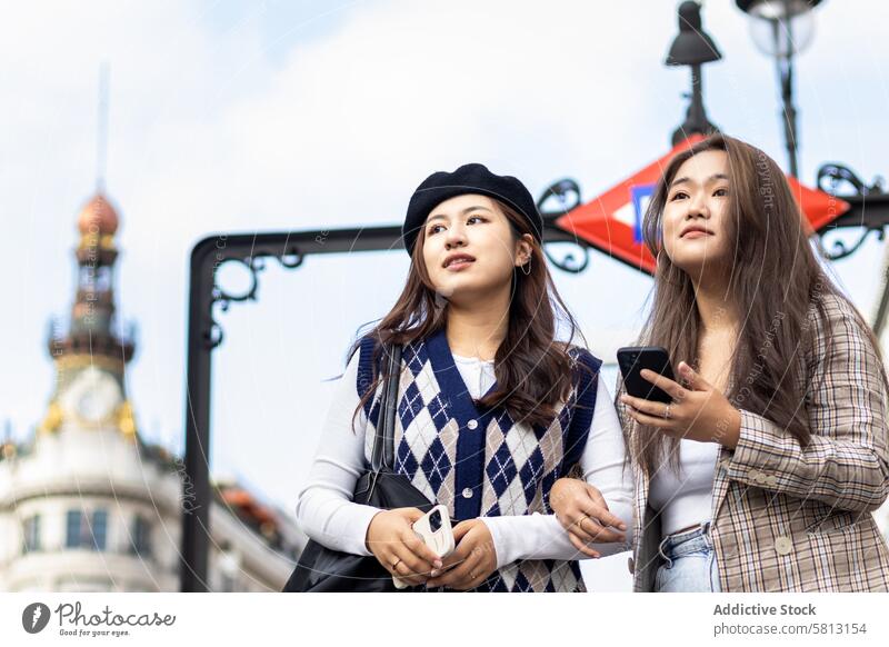 Asian young female friends walking on the street in the city asian people happy lifestyle fun outdoors urban cheerful fashion smiling casual modern youth