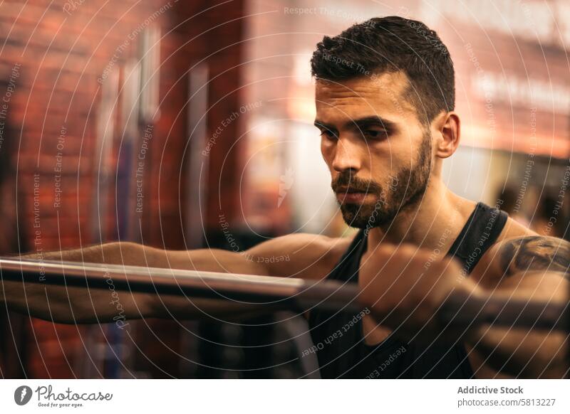 determined strong man focus on training in a gym exercise fitness healthy male workout strength determination muscle muscular lifestyle athletic athlete focused