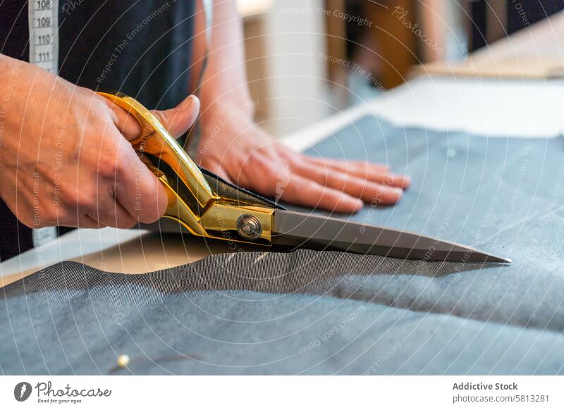 Close-up of fashion designer hands using scissors to cut textile at work table Occupation clothing confidence confident copy space copy-space creativity desk