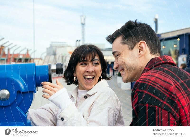 Joyful friends laughing together at the pier laughter joy telescope enjoyment fun day happy moment interaction leisure outdoor casual bonding relationship