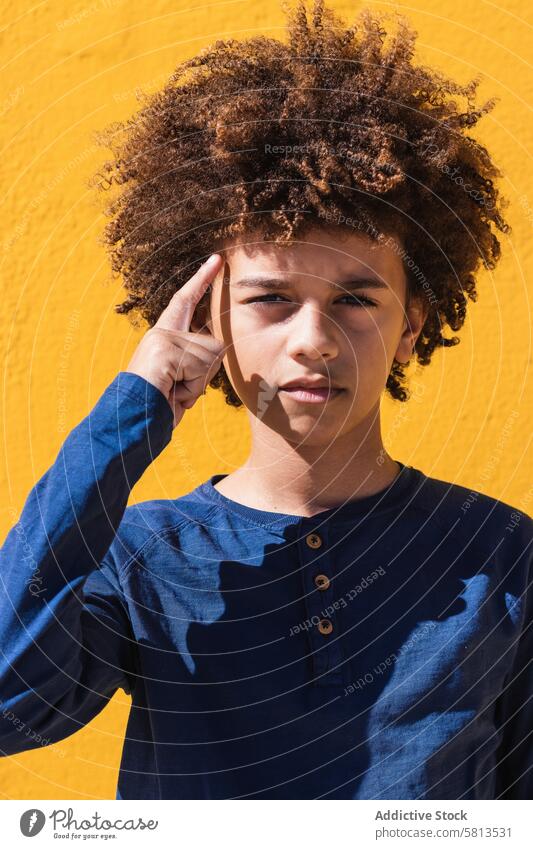 Pensive ethnic boy with Afro hairstyle kid afro curly hair pensive thoughtful teenage think portrait colorful male child ponder youngster serious