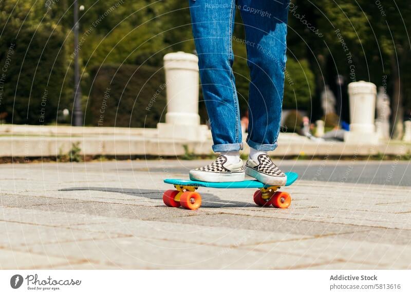 girl skating on a city square. close-up fun skate happy young sport cute summer skater fashion roller woman vintage print art design style cartoon trendy