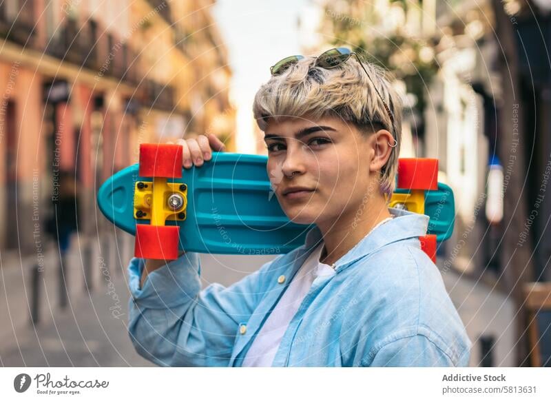 stylish young girl with short hair and a skate. portrait female caucasian skateboard teenager lifestyle woman urban hipster summer people happy skater youth