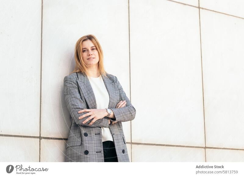 Portrait of a blonde businesswoman in a suit posing and looking at camera with confidence professional executive success entrepreneur finance corporate