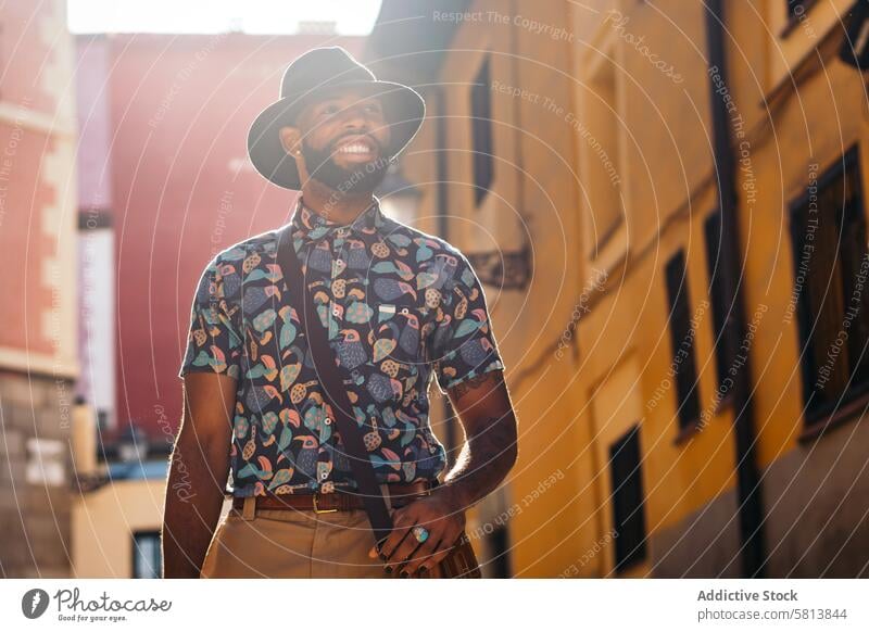 Stylish black man walking on the city street lifestyle young urban male person stylish guy outside people casual outdoors adult fashion summer handsome