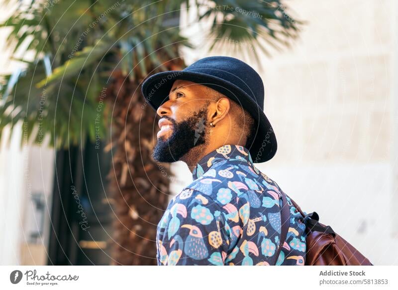 Stylish black man walking on the city street lifestyle young urban male person stylish guy outside people casual outdoors adult fashion summer handsome