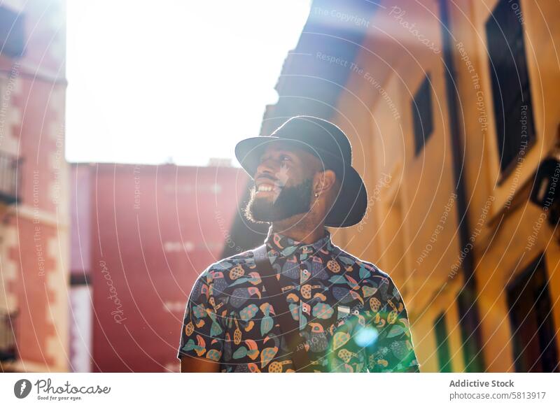 Stylish black man walking on the city street lifestyle young urban male person stylish guy outside people casual outdoors adult fashion summer handsome