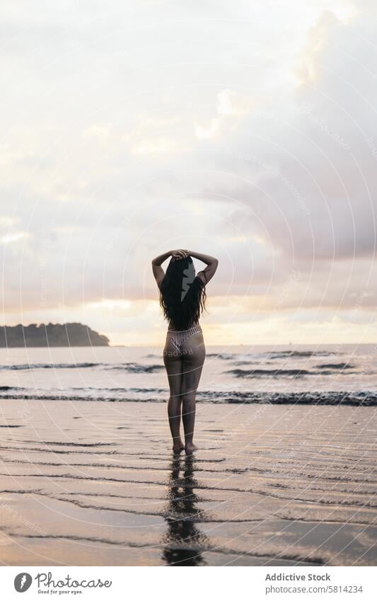 Woman in bikini in front of the sea beach sunset young summer lifestyle woman happy travel beautiful ocean nature vacation people sky female happiness outdoor