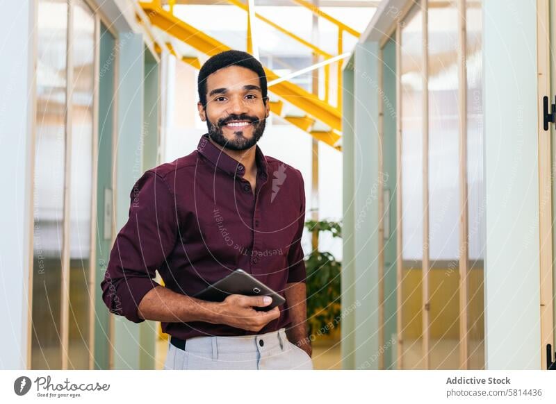 Portrait of smiling african american man in shirt holding tablet in modern office business work worker lifestyle manager businessman professional internet