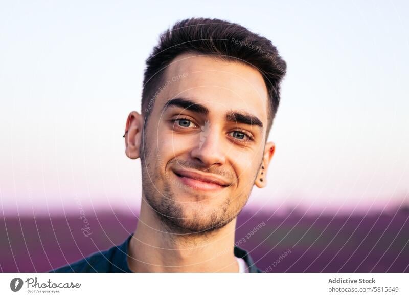 Portrait of a young man in the countryside portrait adult nature happy person summer caucasian outdoors handsome cheerful rural smile smiling field attractive