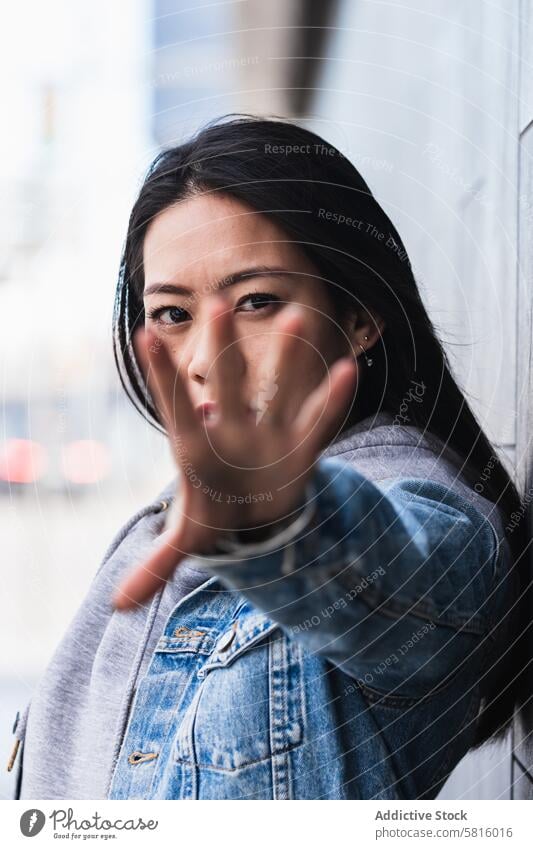 Asian brunette woman with long hair leaning on the wall and looking at camera japanese asian young female model chinese style attractive lady street modern