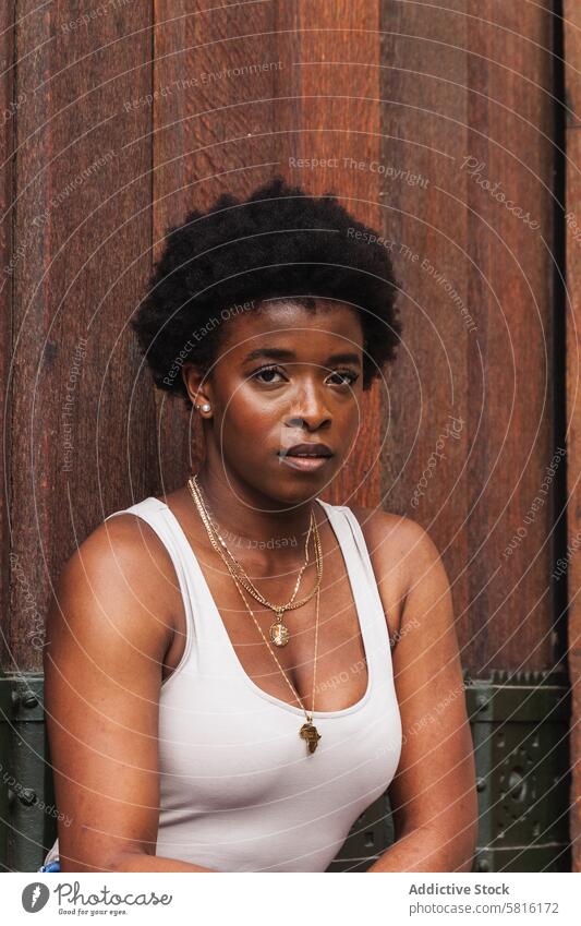 Sad black woman with Afro hairstyle looking at camera unhappy serious trouble upset lonely afro think stress tired sad female thoughtful focus gaze mind mood