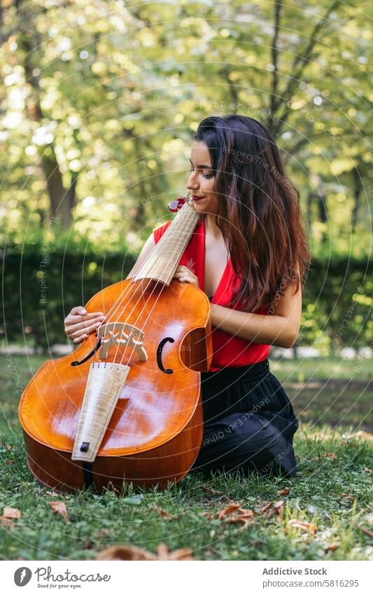 Woman with cello in a park musician woman instrument concert performance artist musical play outdoors classical entertainment orchestra melody symphony sound