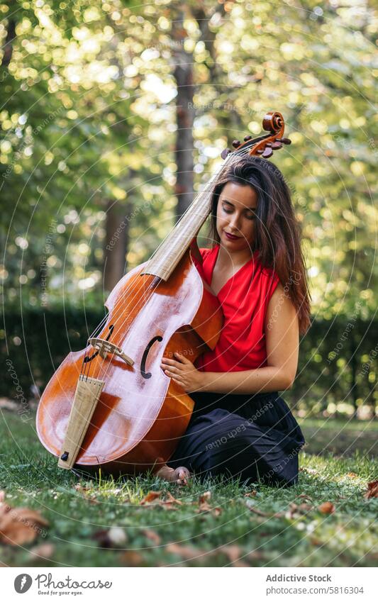 Woman with cello in a park musician woman instrument concert performance artist musical play outdoors classical entertainment orchestra melody symphony sound