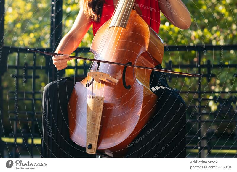 Cropped shot of an unrecognizable woman playing the cello outdoors musician instrument concert performance artist musical classical violin violinist