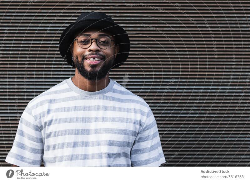 Smiling black hipster man in hat looking at camera happy trendy cheerful smile beard eyeglasses optimist male african american ethnic outfit style positive joy