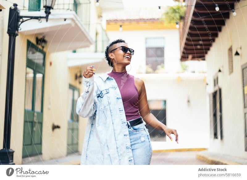 Portrait of a cool Latin American woman walking in the city happy young summer female outdoors people leisure lifestyle photo joyful adult person looking spring