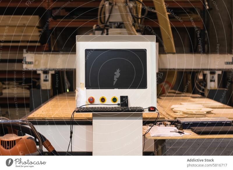 Computer numerical control of machine in workshop computer carpentry old grunge garage shabby machinery industrial equipment manufacture old fashioned tool aged