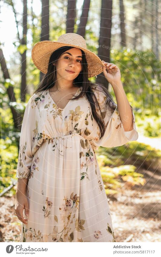 Woman with a straw hat in the forest female young nature park lifestyle walk leisure outdoors landscape sunny leaves tree caucasian walking holiday happiness