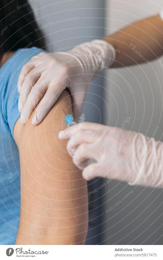 Nurse giving a vaccine to a patient doctor injection medicine coronavirus immunization hospital nurse syringe mask clinic protection health medical prevention