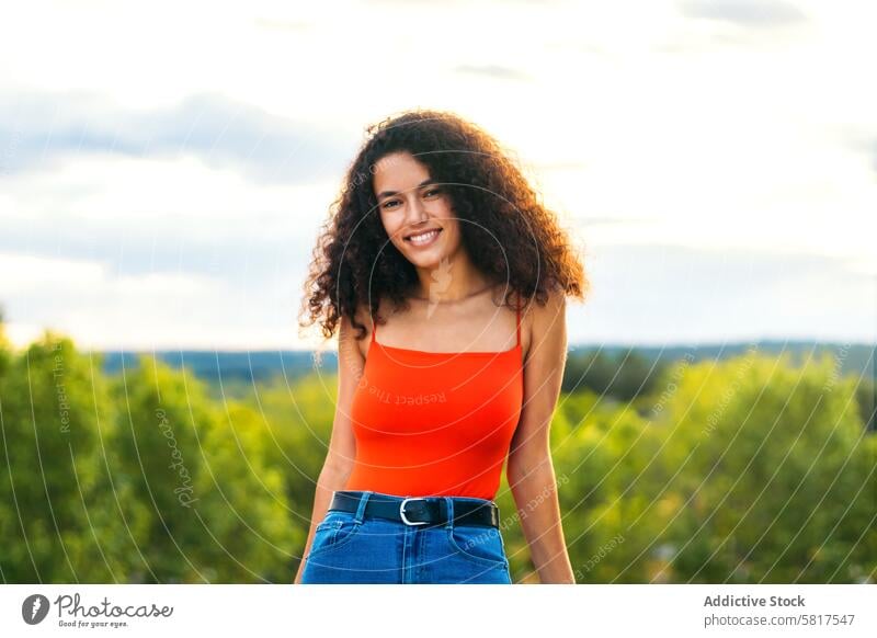 attractive woman with curly hair portrait on a terrace female girl happy beautiful young adult beauty lifestyle person summer pretty balcony white people