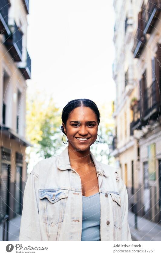 Portrait of a cheerful African American young woman outdoors happy park street city casual smile lifestyle people adult fun summer smiling outside urban