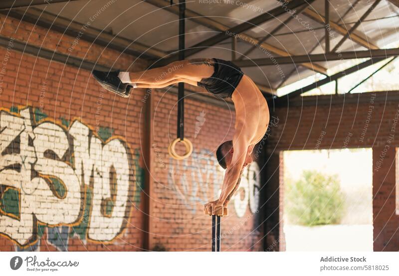 man athlete doing a mexican handstand. calisthenics fit sport strength vertical fitness active caucasian exercise athletic muscle training young muscular male