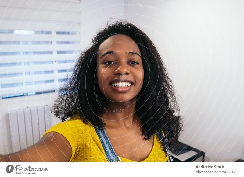 Smiling Selfie: Young Black Woman in Yellow Shirt Black woman Yellow shirt Smartphone Technology Self-expression Happiness Joy Candid Diversity Ethnicity