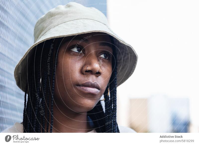 Young black woman in hat style casual appearance urban modern summer outfit young portrait braid female african american ethnic model hipster individuality