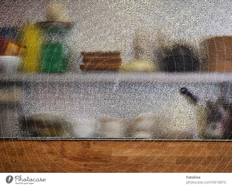 Kitchen utensils are dimly visible through a milky pane of glass. The food was very tasty. Restaurant kitchen utensils bowls Hazy Glass Pane Bowl Wood Green