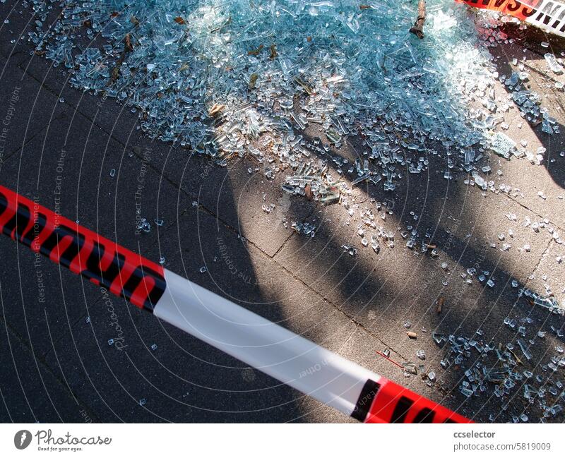 Shards of glass from a destroyed bus stop lie on the asphalt Broken glass Vandalism Destruction Glass Damage Bus stop Public transit public space