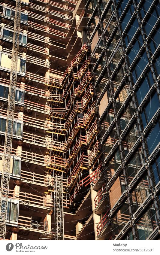 Shell construction and core renovation of a modern high-rise building with luxury apartment with construction crane and scaffolding at Grüneburgpark in the Westend of Frankfurt am Main in Hesse