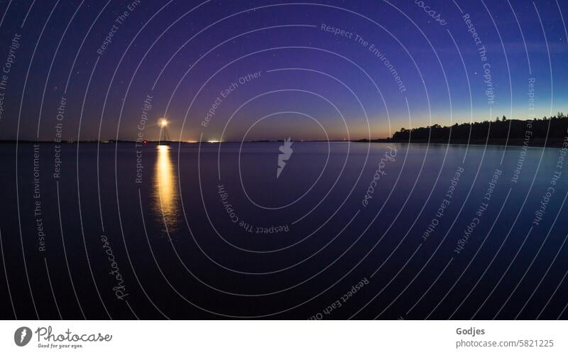 Night shot on the water, light star of a ship's mast is reflected in the water, sky is starry star of light Pole reflection Water Starry sky Forest Starlit