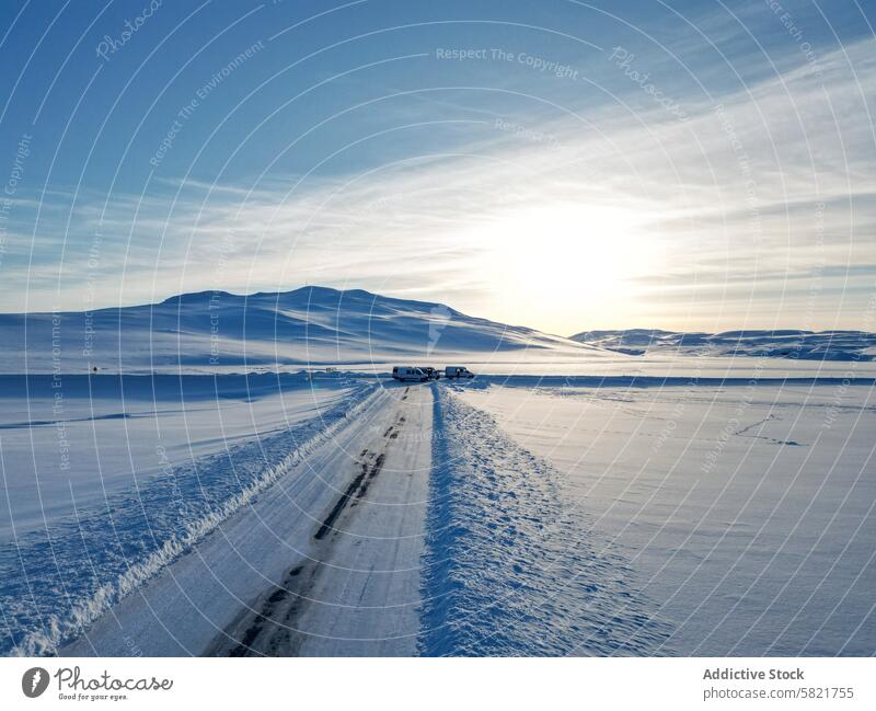 Winter road through snowy landscape in Iceland iceland winter sky blue mountain vehicle serene clear distant parked vast scenic travel cold frozen nature