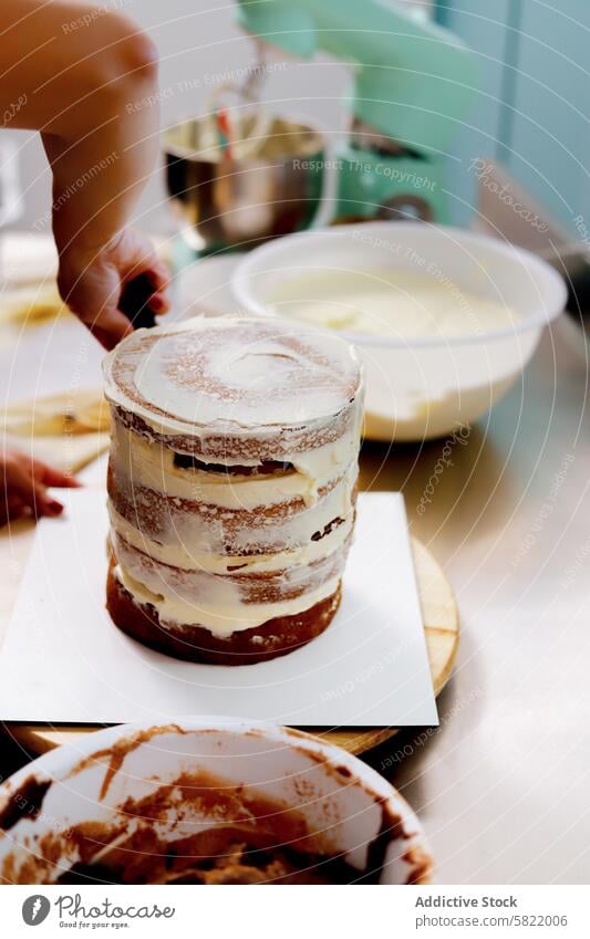 Layering a Homemade Cake with Creamy Frosting cake frosting layering baking homemade kitchen mixer bowl creamy unfinished cooking dessert spatula ingredient