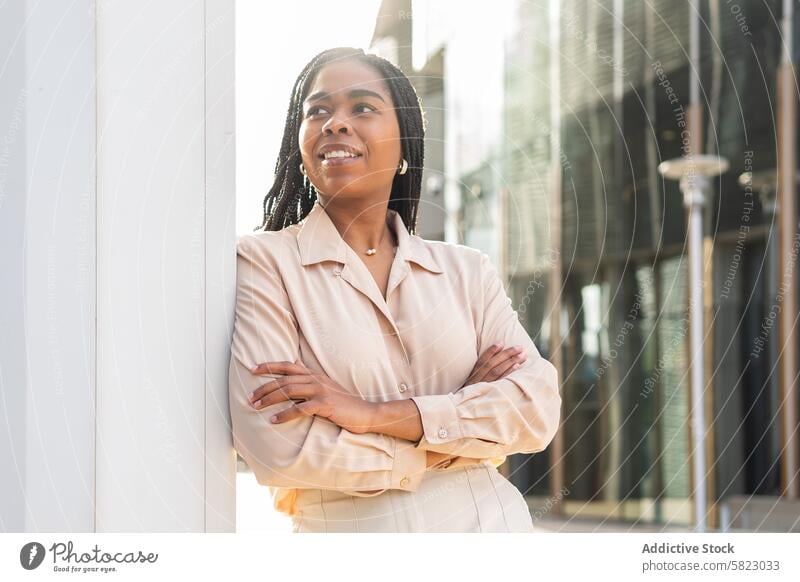 Smiling woman enjoying summer in Barcelona smile barcelona confidence casual sun street daylight joyful happy city urban lifestyle outdoor arms crossed positive