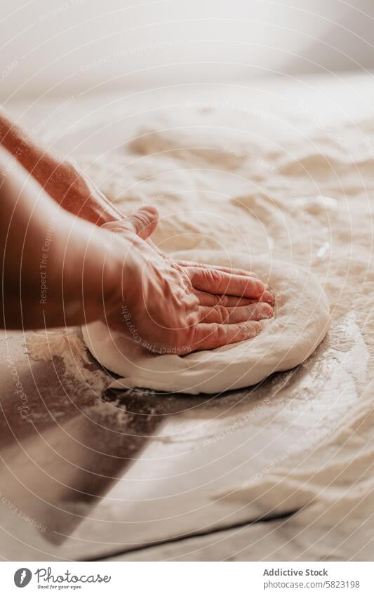 Expert Hands Kneading Pizza Dough on Flour-Dusted Surface pizza dough kneading flour hands preparation baking cooking kitchen pizzeria artisan crop