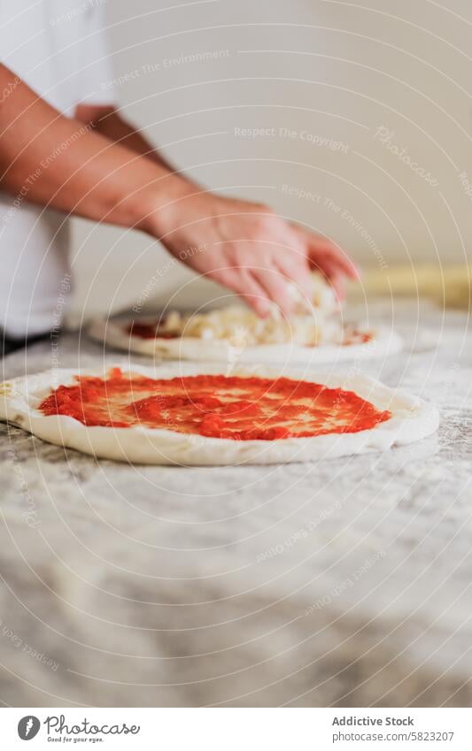 Preparing Handmade Pizza in a Pizzeria Kitchen pizza preparation dough tomato sauce cheese chef handmade pizzeria kitchen restaurant cooking food italian