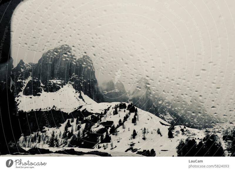 Bad weather in the mountains Rain raindrops Snow Window pane Mountain tops Damp Gloomy rainy Drop Drops of water Wet Weather Rainy weather rainy day