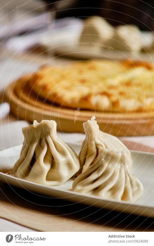 Traditional Georgian dishes, khachapuri and khinkali, served on wooden table georgian cuisine cheese bread dumpling food meal traditional cultural gourmet dough