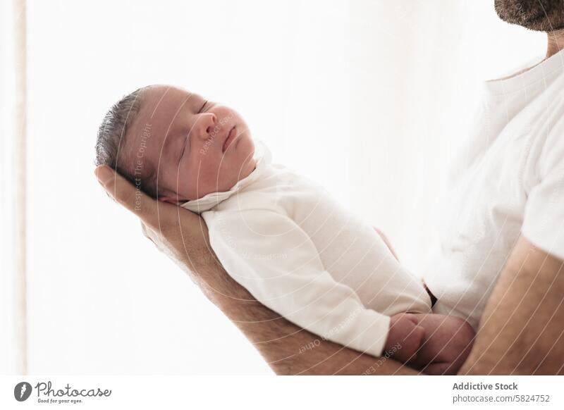 Serene newborn baby cradled in parent's arms infant sleep peaceful serene innocence love support child care tenderness safety comfort rest slumber hold coziness