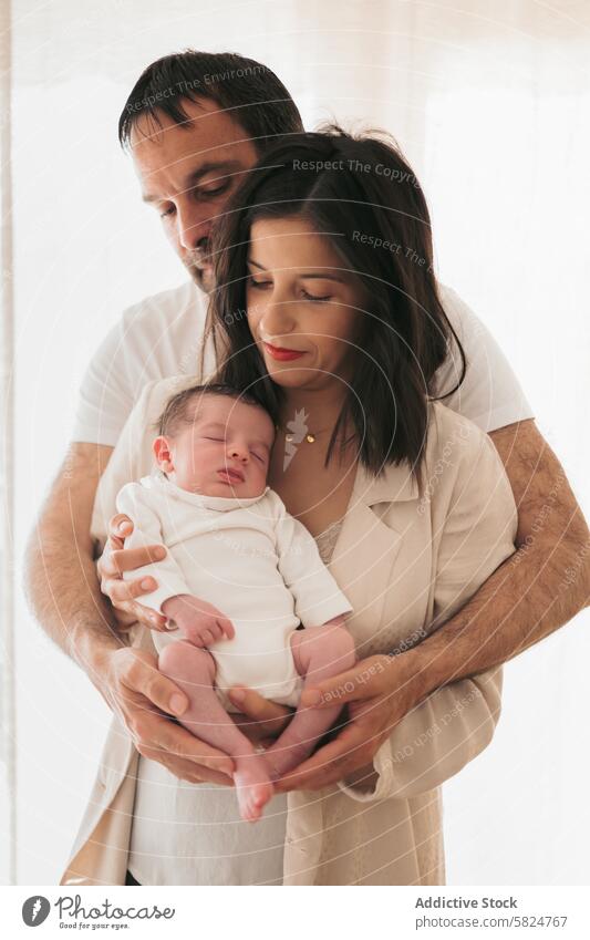 Tender moment with newborn in parents' embrace family baby mother father love tender couple together infancy sleeping child care affection bonding happiness