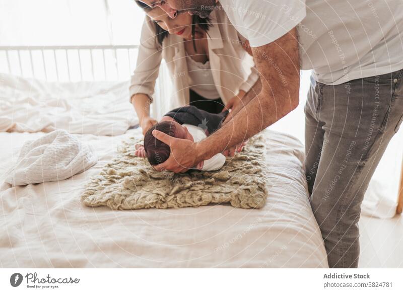 Tender moment with newborn and loving parents baby family tender love affection interaction couple blanket comfort gentle care nurturing bonding together