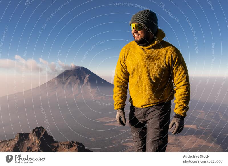 Smiling hiker enjoying a sunny day at Iztaccihuatl iztaccihuatl volcano mountain adventure outdoor hiking trail summit ridge fleece yellow smile cheerful nature