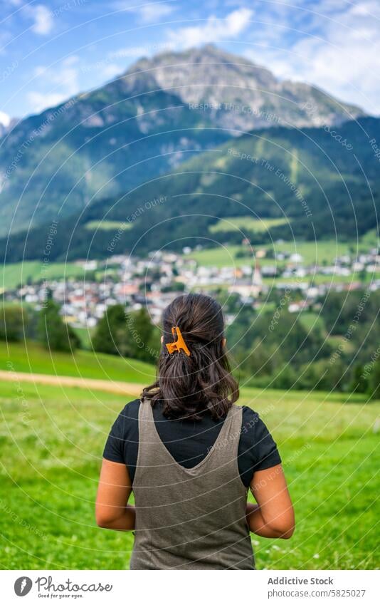 Woman gazing at mountainous landscape in the Alps woman back view alps italian alps austrian alps valley nature green adventure tranquility peak travel