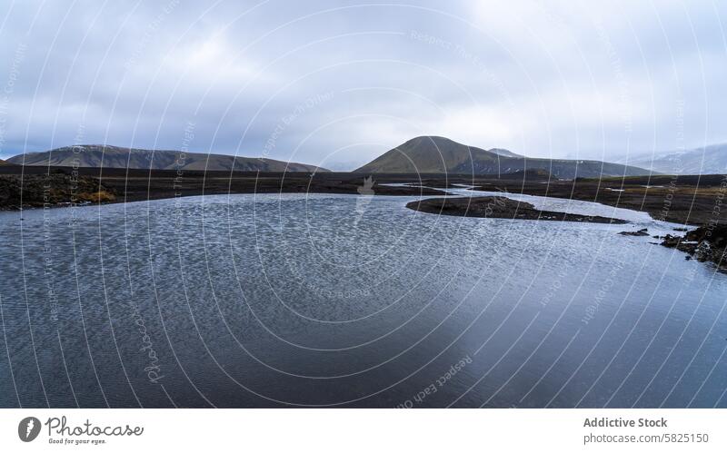 Serene waters and rolling hills in the Iceland highlands iceland landscape serene tranquil overcast sky nature outdoor scenic view travel tourism adventure