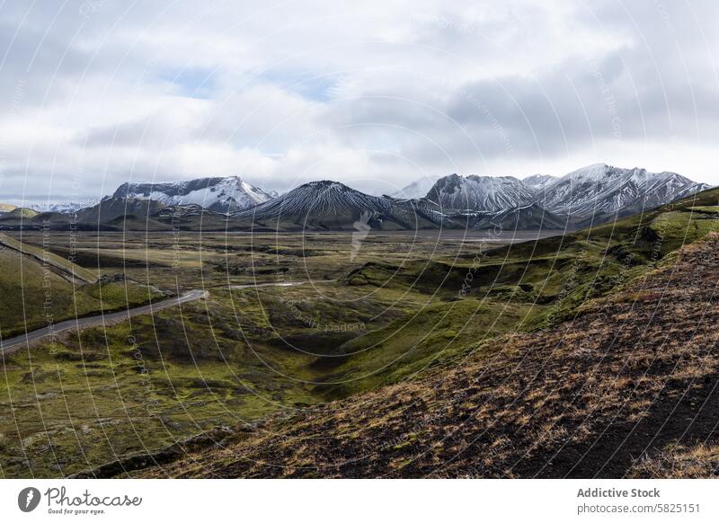 Dramatic Iceland Highlands landscape with snow-capped mountains iceland highlands peaks rugged terrain wilderness road winding majestic dramatic view nature