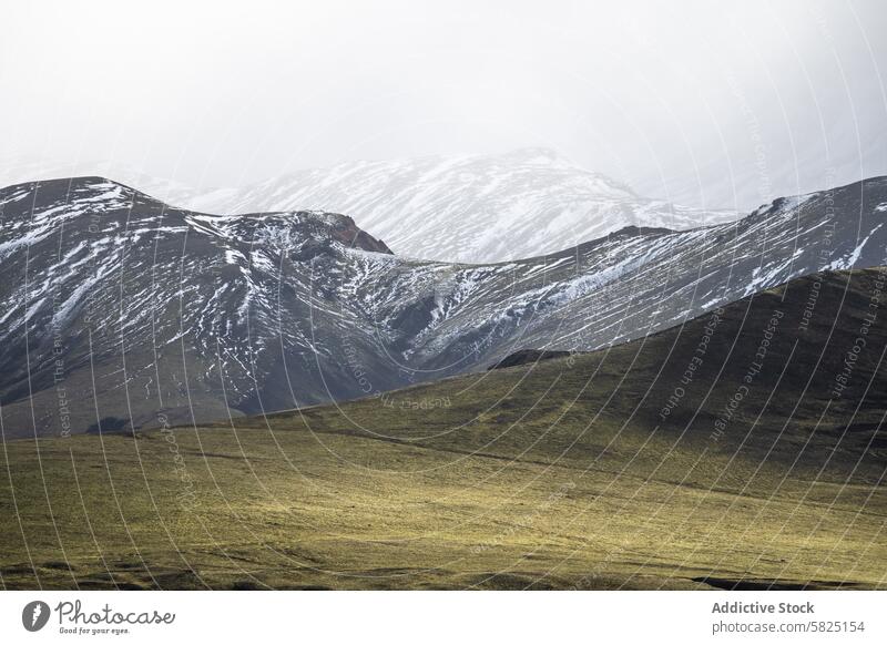 Serene Icelandic Highlands with Snow-Capped Peaks landscape icelandic highlands snow mountain hill serene tranquil nature outdoors majesty calm hazy sky peak