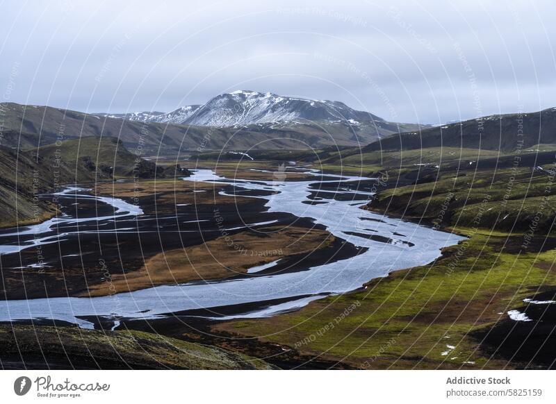 Serene river winding through Iceland's majestic highlands iceland valley volcanic hill tranquil nature splendor landscape water stream meander green serene