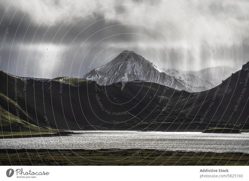 Majestic mountain peak in the Icelandic Highlands iceland highland snow-capped cloud lake serene rugged landscape nature outdoor scenic view majestic